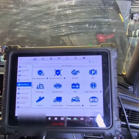 A diagnostic tablet plugged into a customer's car
