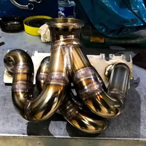 A hand-made stainless exhaust manifold on the bench